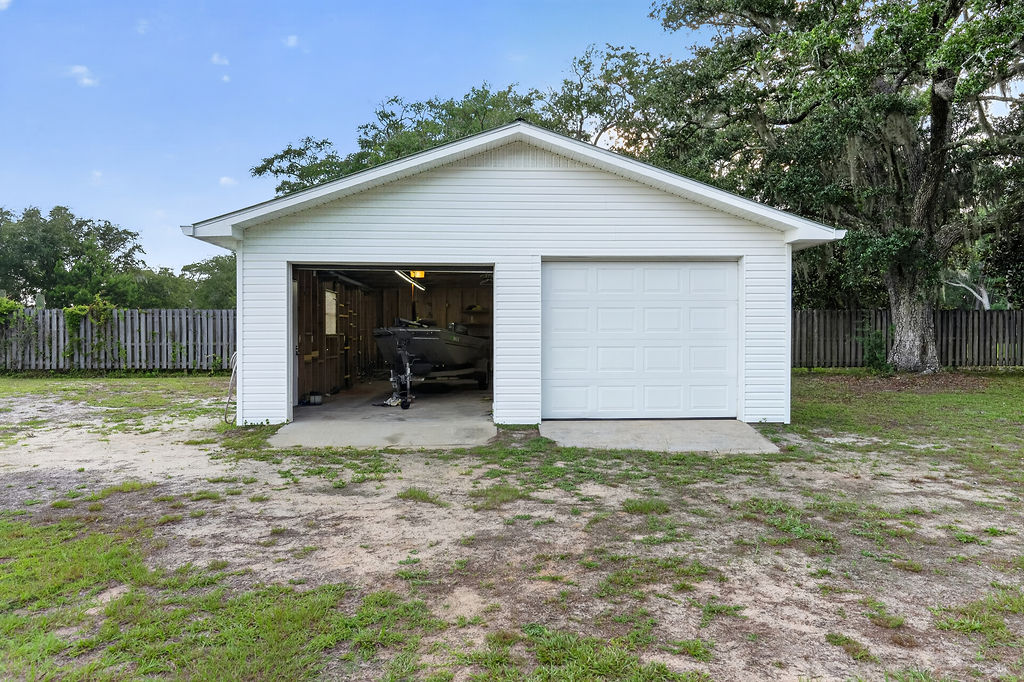 Detached two-car garage with a boat parked inside