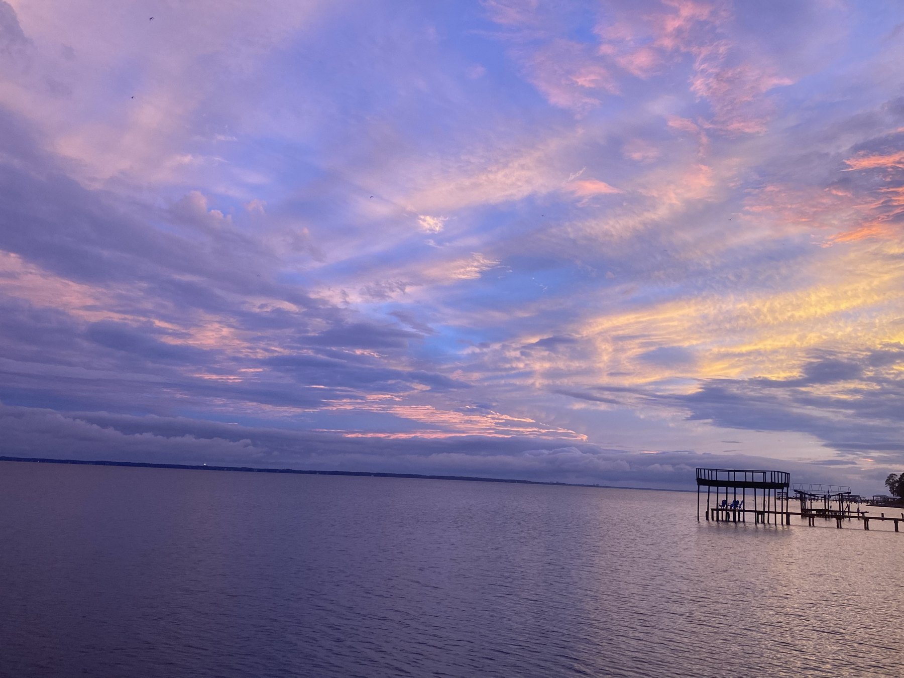 Dusk light and clouds over the open water of the bay