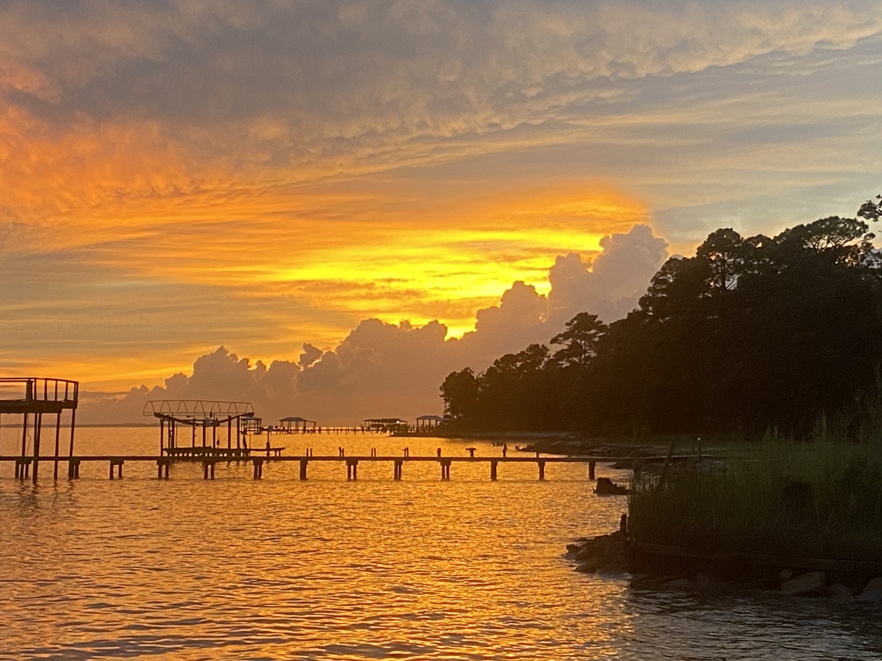 Orange sunset over Choctawhatchee Bay seen from the property